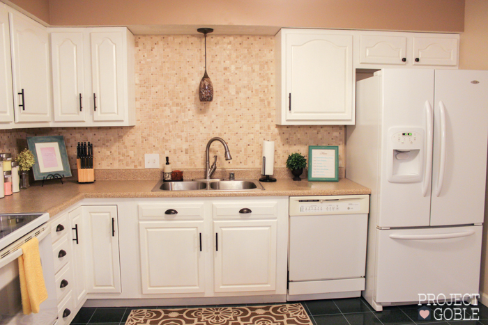 AFTER Kitchen Transformation // White Cabinets & White Appliances // Check blog for details on what was used to transform their oak kitchen cabinets to white and their countertops to a granite look! It's Affordable too!