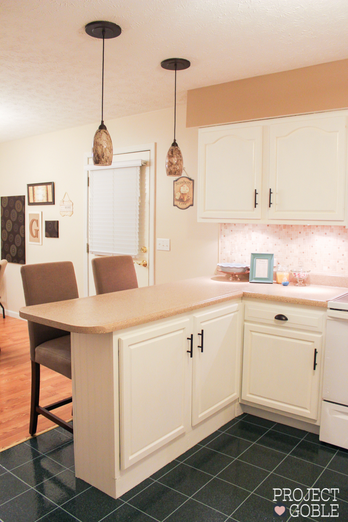 AFTER Kitchen Transformation // White Cabinets & White Appliances // Check blog for details on what was used to transform their oak kitchen cabinets to white and their countertops to a granite look! It's Affordable too!