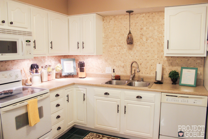 AFTER Kitchen Transformation // White Cabinets & White Appliances // Check blog for details on what was used to transform their oak kitchen cabinets to white and their countertops to a granite look! It's Affordable too!