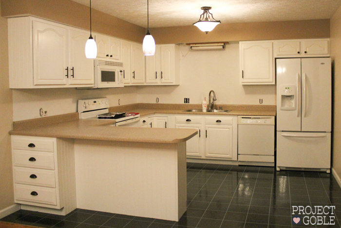 AFTER Kitchen Transformation // White Cabinets & White Appliances // Check blog for details on what was used to transform their oak kitchen cabinets to white and their countertops to a granite look! It's Affordable too!